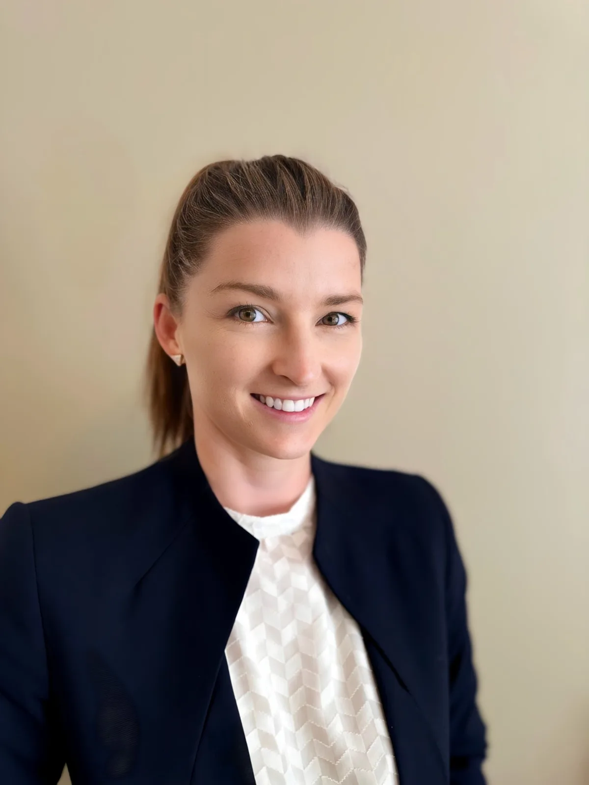 Lauren Cairns, AI consultant, smiling in a navy blazer